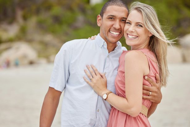 Love, smile and couple outdoor portrait at the beach for the holiday vacation. Happy marriage with